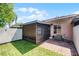 Cozy backyard with a screened-in patio, artificial grass, and brick pavers at 1312 Azalea Way, Winter Garden, FL 34787