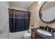 Full bathroom with dark vanity, shower with curtain and modern fixtures at 1312 Azalea Way, Winter Garden, FL 34787