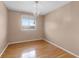 A bedroom with hardwood floors, a neutral paint scheme, and a window at 1312 Azalea Way, Winter Garden, FL 34787
