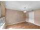 Cozy bedroom featuring hardwood floors, a window, and neutral paint tones at 1312 Azalea Way, Winter Garden, FL 34787
