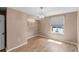 Bedroom with a view and an open closet with hardwood floors at 1312 Azalea Way, Winter Garden, FL 34787