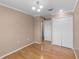 Bedroom with hardwood floors, a neutral paint scheme, and closet space at 1312 Azalea Way, Winter Garden, FL 34787