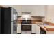 Modern kitchen with stainless steel appliances, wood countertops, and white cabinets at 1312 Azalea Way, Winter Garden, FL 34787