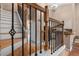 Elegant staircase with wooden steps and ornate metal railings leading to the upper level at 1312 Azalea Way, Winter Garden, FL 34787