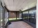 Enclosed sunroom features brick flooring, updated windows, and modern lighting with backyard view at 1312 Azalea Way, Winter Garden, FL 34787