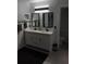 Elegant bathroom with double vanity, sleek black fixtures, and ample lighting at 13200 Mallard Cove Blvd, Orlando, FL 32837
