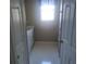 Bathroom featuring vanity with drawers and a window, accessible through two doorways at 13200 Mallard Cove Blvd, Orlando, FL 32837