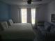 Cozy bedroom featuring a bed and a couch with natural light from the windows at 13200 Mallard Cove Blvd, Orlando, FL 32837