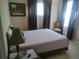Cozy bedroom featuring neutral walls, soft lighting, and a comfortable bed with a wooden chair at 13200 Mallard Cove Blvd, Orlando, FL 32837