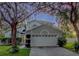 Charming two-story home featuring a two-car garage and mature landscaping at 13200 Mallard Cove Blvd, Orlando, FL 32837
