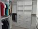 Walk-in closet features ample clothing racks, built-in shelving, drawers, and base cabinets at 13200 Mallard Cove Blvd, Orlando, FL 32837