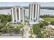 Stunning aerial view of twin high-rise condos with gorgeous lake views, lush landscaping, and a miniature golf course at 13427 Blue Heron Beach Dr # 404, Orlando, FL 32821