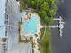 Overhead aerial view of the pool, hot tub, and lakeside pier, showcasing the condo's outdoor amenities and relaxing atmosphere at 13427 Blue Heron Beach Dr # 404, Orlando, FL 32821