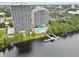 Aerial view of the condominium complex with swimming pool, lush trees, and access to the lake at 13427 Blue Heron Beach Dr # 404, Orlando, FL 32821