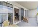 Outdoor balcony with outdoor chairs, views of water and the indoor living space at 13427 Blue Heron Beach Dr # 404, Orlando, FL 32821