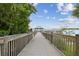 Picturesque view of a wooden community pier leading to a gazebo, perfect for enjoying serene lake views at 13427 Blue Heron Beach Dr # 404, Orlando, FL 32821