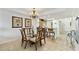 Open concept dining room with glass table, chandelier, and views into kitchen and laundry room at 13427 Blue Heron Beach Dr # 404, Orlando, FL 32821