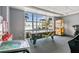 Game room with air hockey table and assorted games, offering leisure by the large window with outdoor views at 13427 Blue Heron Beach Dr # 404, Orlando, FL 32821