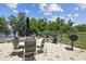 Outdoor grilling area with multiple grills, tables, chairs and a beautiful lake view, perfect for entertaining at 13427 Blue Heron Beach Dr # 404, Orlando, FL 32821