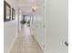 Interior hallway with tile flooring, framed prints and partial view of a seating area and exterior view at 13427 Blue Heron Beach Dr # 404, Orlando, FL 32821