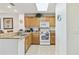 Well-lit kitchen features light cabinetry and stainless steel appliances at 13427 Blue Heron Beach Dr # 404, Orlando, FL 32821