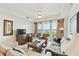 Comfortable living room features tile floors, fan, comfortable seating, and large windows overlooking the water at 13427 Blue Heron Beach Dr # 404, Orlando, FL 32821