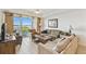 Bright living room with plush seating, tile floors, and large windows bringing in natural light at 13427 Blue Heron Beach Dr # 404, Orlando, FL 32821