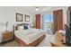 Cozy main bedroom with balcony access and views of the water at 13427 Blue Heron Beach Dr # 404, Orlando, FL 32821