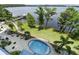 Scenic waterfront view featuring a tranquil lake, dock, and lush landscaping, enhancing the property's natural beauty at 13427 Blue Heron Beach Dr # 404, Orlando, FL 32821