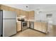 Functional kitchen with stainless steel appliances, tile backsplash, and wood cabinets at 1447 Candlewyck Dr, Orlando, FL 32807
