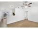 Open living room with tile flooring, leading to the kitchen and backyard at 1447 Candlewyck Dr, Orlando, FL 32807