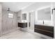 Modern bathroom featuring dual vanities, LED mirrors, and a spacious glass-enclosed shower at 1511 E Horatio Ave, Maitland, FL 32751