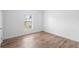 Bedroom with wood-look tile flooring and bright natural light at 1511 E Horatio Ave, Maitland, FL 32751