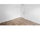 Empty bedroom with wood-look tile flooring, closet, and door at 1511 E Horatio Ave, Maitland, FL 32751
