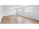 Sunlit bedroom featuring wood-look tile flooring and a view of the exterior at 1511 E Horatio Ave, Maitland, FL 32751