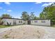 Charming single-story home featuring a neatly paved driveway and lush landscaping at 1511 E Horatio Ave, Maitland, FL 32751