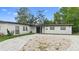 Charming single-story home with a well-manicured front yard and brick paved driveway at 1511 E Horatio Ave, Maitland, FL 32751