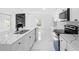 Bright, modern kitchen with white cabinetry, a black backsplash, and sleek countertops at 1511 E Horatio Ave, Maitland, FL 32751