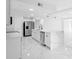 Modern kitchen with marble floors, an island, and updated stainless-steel appliances at 1511 E Horatio Ave, Maitland, FL 32751