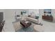 Bright living room featuring a modern sofa, stylish accent chair, and elegant marble flooring at 1511 E Horatio Ave, Maitland, FL 32751
