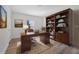 Home office with a built-in bookcase and wood-look tile flooring at 1511 E Horatio Ave, Maitland, FL 32751