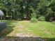 View of the backyard, offering plenty of space and shade, ideal for outdoor activities and enjoyment at 1525 Hilltop Rd, Casselberry, FL 32707