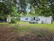View of the home's rear exterior and yard, showing the additional potential for outdoor enjoyment and expansion at 1525 Hilltop Rd, Casselberry, FL 32707