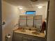 Bright bathroom featuring a double sink vanity and a large three-pane mirror at 1525 Hilltop Rd, Casselberry, FL 32707