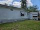 Side view of the single-story home with tidy siding and window awnings, highlighting its well-maintained exterior features at 1525 Hilltop Rd, Casselberry, FL 32707