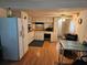 Open kitchen and dining area with white cabinets and appliances, offering a functional and inviting space for meals and gatherings at 1525 Hilltop Rd, Casselberry, FL 32707