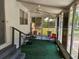 Cozy screened porch with seating, offering a peaceful outdoor retreat with views of the surrounding neighborhood and landscape at 1525 Hilltop Rd, Casselberry, FL 32707