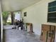 Enclosed porch showing concrete flooring, white siding, and a screened exterior view at 1525 Hilltop Rd, Casselberry, FL 32707