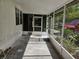 Enclosed porch with ample natural light, featuring concrete floors and providing extra outdoor space at 1525 Hilltop Rd, Casselberry, FL 32707