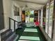 Cozy screened-in porch with carpeted floor and comfortable seating, perfect for enjoying the outdoors at 1525 Hilltop Rd, Casselberry, FL 32707